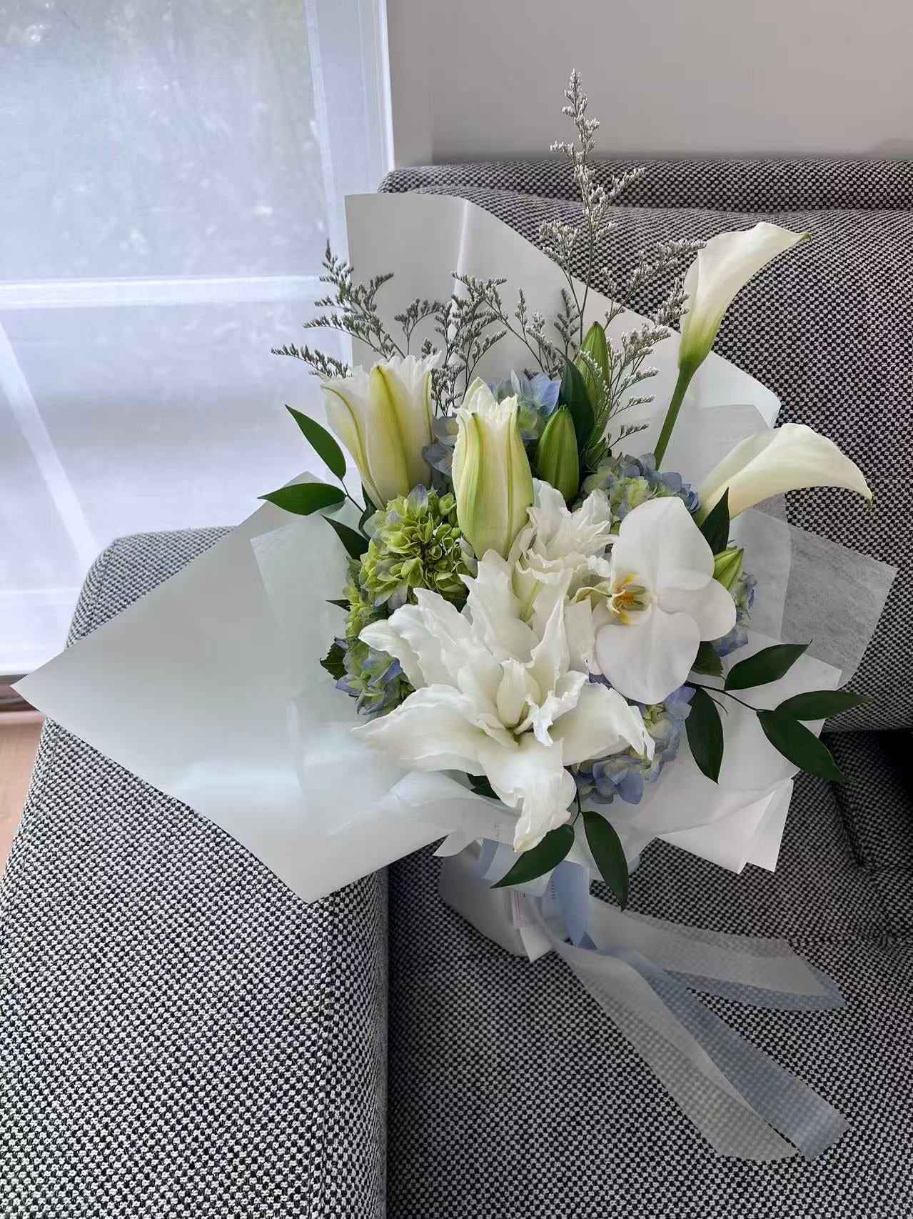 Blue hydrangea and white lily bouquet