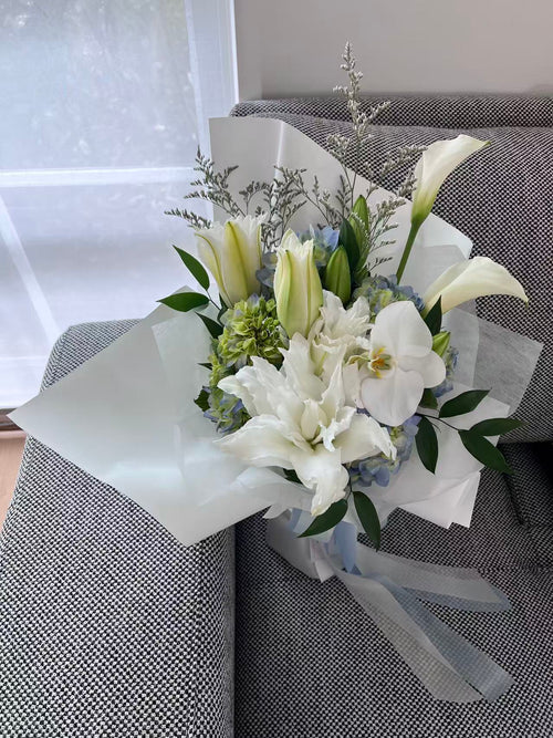 Blue hydrangea and white lily bouquet
