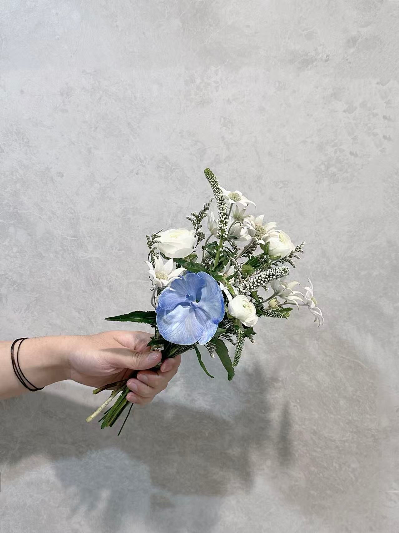 Ivory and blue flower bouquet with greenery