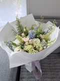Pink spray rose, blue delphinium and lisianthus bouquet