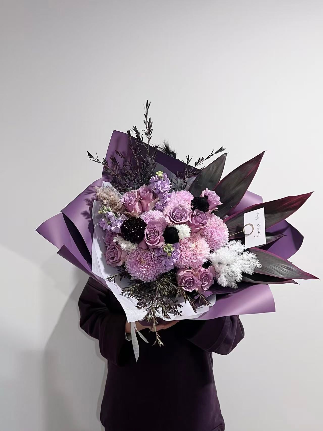 Purple and pink rose bouquet with burgundy flowers