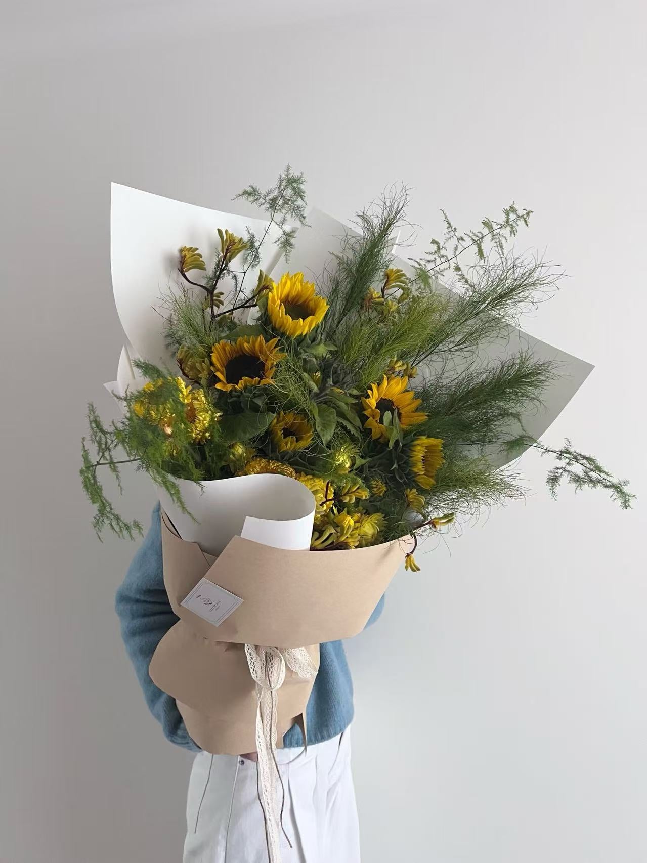 Sunflower bouquet with wild greenery