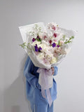 White rose bouquet with plum flowers and cymbidium orchids